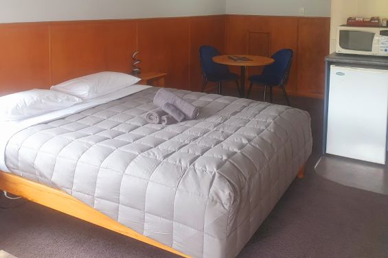 Upstairs Studio with Balcony bed and table